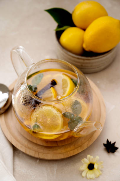 istock Glass teapot with fruit citrus tea on bright background. Herbal delicious healthy tea 1340066452