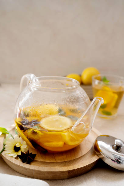 istock Glass tea pot with fruit delicious herbal tea on bright background. 1340066511