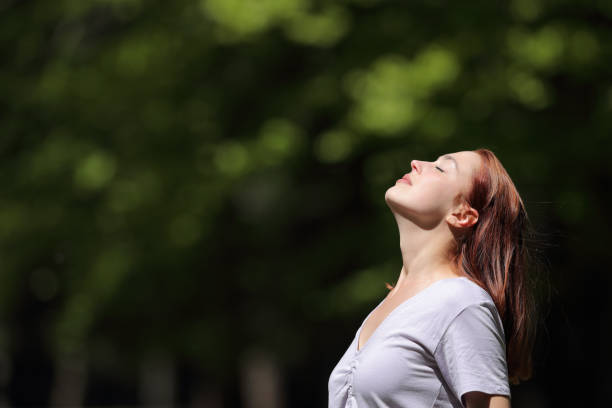 istock Woman breathing and heating under sun in a park 1340066994