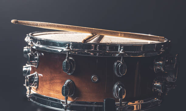 istock Close-up snare drum and drum sticks on a dark background. 1340067707
