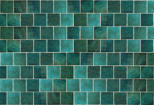 Green ceramic tile background. Old vintage ceramic tiles in green to decorate the kitchen or bathroom. High quality photo