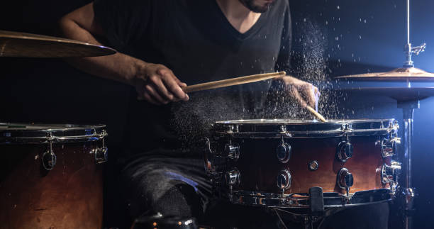 istock The drummer plays the snare drum with splashing water. 1340067792