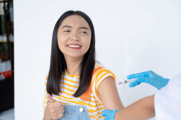 istock Young girl taking a vaccination. Virus protection. on white background. 1340068178