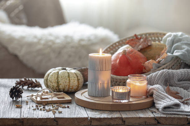 istock Cozy autumn composition with candles and pumpkins in a home interior. 1340068185