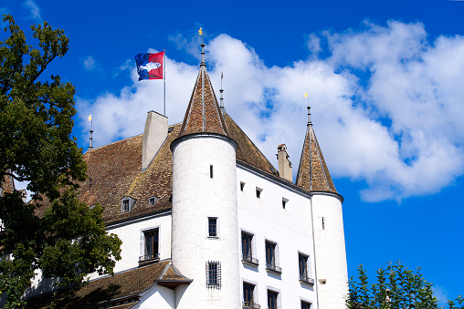 White medieval castle at the old town of Nyon on a sunny summer day. Photo taken August 28th, 2021, Nyon, Switzerland.
