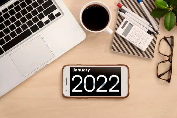Photo of January 2022.Calendar on mobile phone for Planner and organizer to plan and reminder daily appointment, meeting agenda, schedule, timetable and management of job, Work from home.