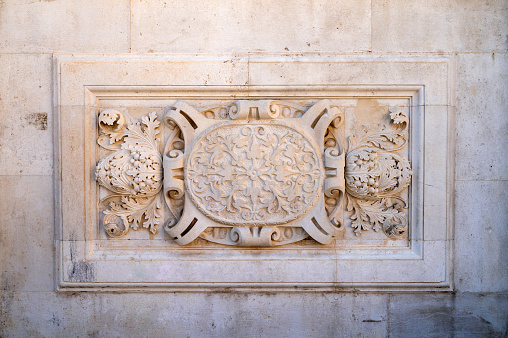 Architectural detail of old building. Stone frame. Bas-relief board