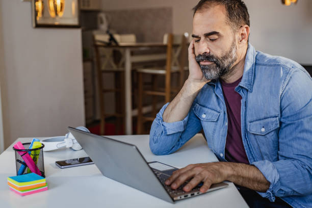 istock Man working on the laptop at home 1340071799