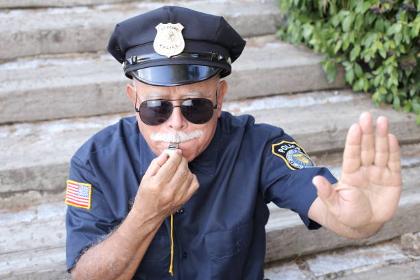 istock Senior American policeman showing stop hand sign 1340072644