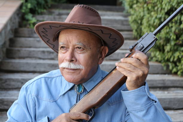 istock Senior Mexican rancher with a riffle 1340072672