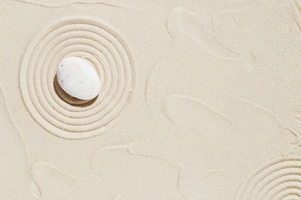 istock Zen garden meditation sandy background  White stone and lines on sand 1340078818