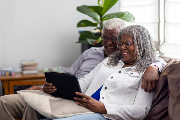 istock Senior Black Couple Using Smart Devices together at home 1340080434