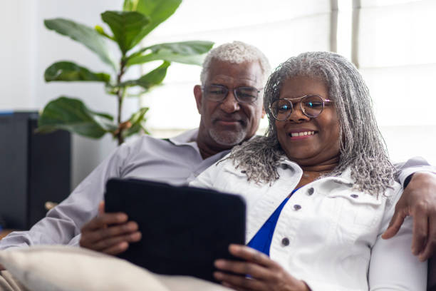 istock Senior Black Couple Using Smart Devices together at home 1340080473