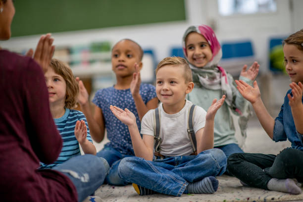 istock Kindergarten children clapping their hands in a classroom 1340083507