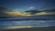 istock 4k Nature video sunset The scenery, beaches, natural beauty and wonders.  sunset in the sea On a beautiful day, the sky is golden yellow  and the sea waves wash on the beautiful soft sandy beach 1340083801