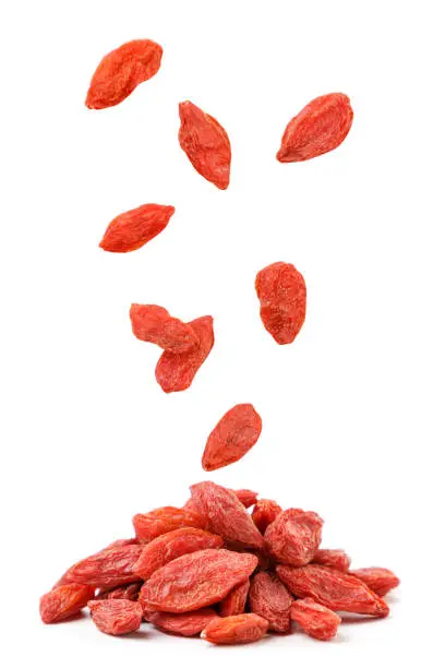Dry goji berries fall on a heap close-up on a white background. Isolated