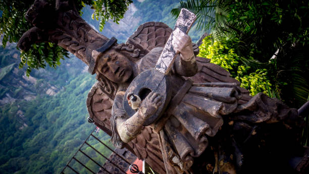 istock Small bird in the hand of a stone statue 1340087501