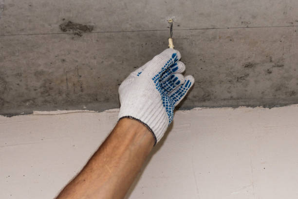 istock Installation of plastic dowels for hangers. 1340087630