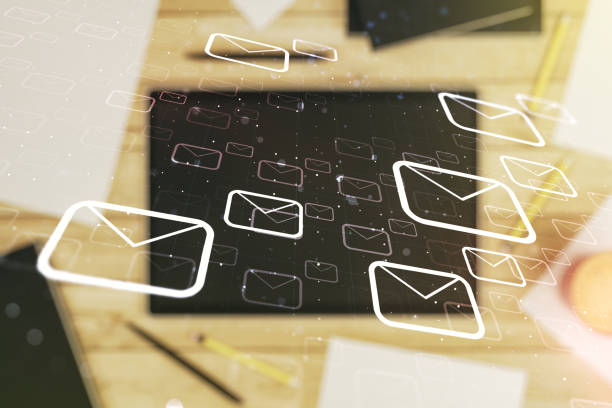 istock Double exposure of postal envelopes hologram and modern digital tablet on background, top view. Electronic mail and spam concept 1340087640