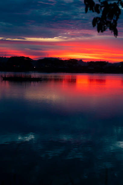 istock a view of the lake at night with an orange-blue gradient sky that makes its color reflection into the lake water 1340088928