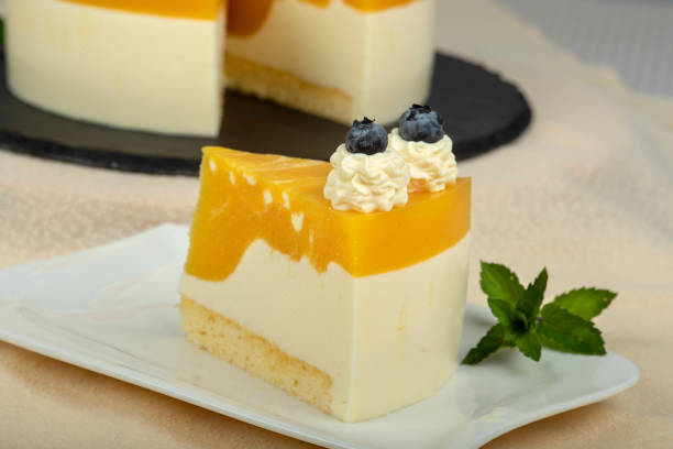 istock Mango cheesecake with cream cheese garnished with cream and blueberries 1340089001