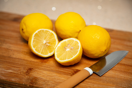 Yellow lemon cut on the cutting board，Fresh fruit, vegetarian concept
