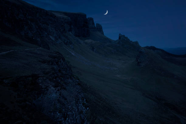 Evening moon over The Quiraing, a landslip on the eastern face of Meall na Suiramach, on the Isle of Skye, Scotland