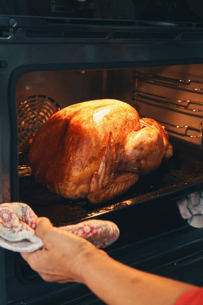 istock Roasting Turkey in the Oven for Holiday Dinner 1340091995