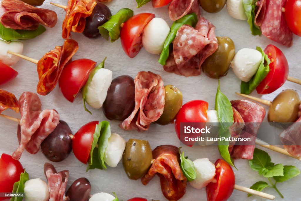 Antipasto Skewers Antipasto Skewers with Mozzarella, Cherry Tomatoes, Basil, Olives and Salami Skewer Stock Photo
