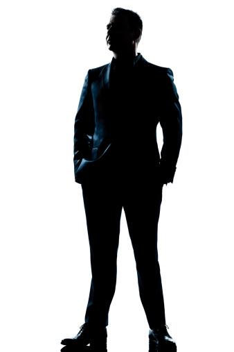 one caucasian  business man  handsome full suit standing full length serious silhouette in studio   white background