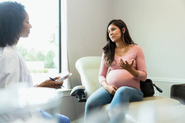 istock Doctor listens while pregnant patient asks about medication side effects 1340094886