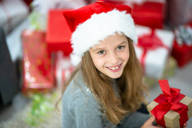 istock Little girl holding a Christmas gift 1340096355