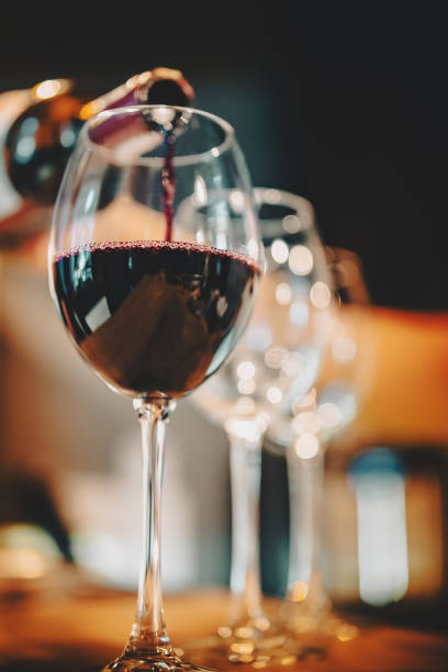 istock bartender pouring red wine into a glass in cafe or bar 1340097939