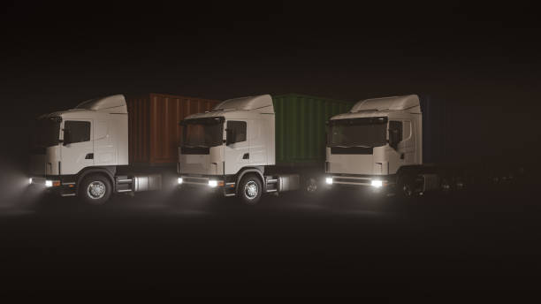 istock Container Trucks with Red Green and Blue Containers Lined Up in the Dark 1340098354