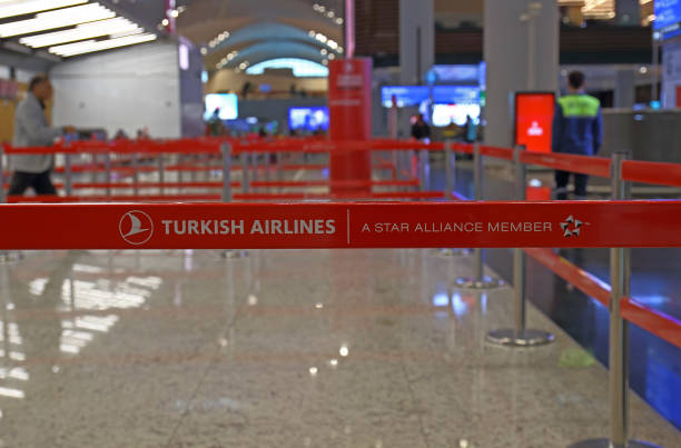 red plastic tapes of Turkish Airlines in Istanbul, Turkey Istanbul, Turkey - October 11, 2019: Empty check-in area with red plastic tapes of Turkish Airlines in new main Istanbul International Airport. priority baggage tag stock pictures, royalty-free photos & images