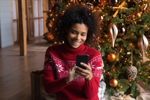istock Happy biracial woman use cellphone on holidays 1340098646