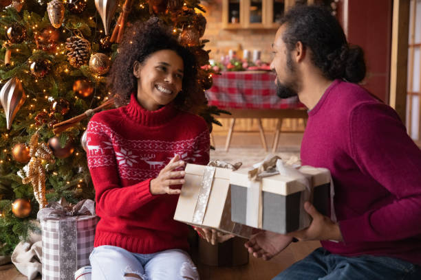istock Smiling couple exchange presents on New Year 1340098808