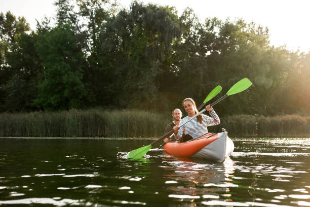istock Active young caucasian couple kayaking on river with trees in the background 1340099890
