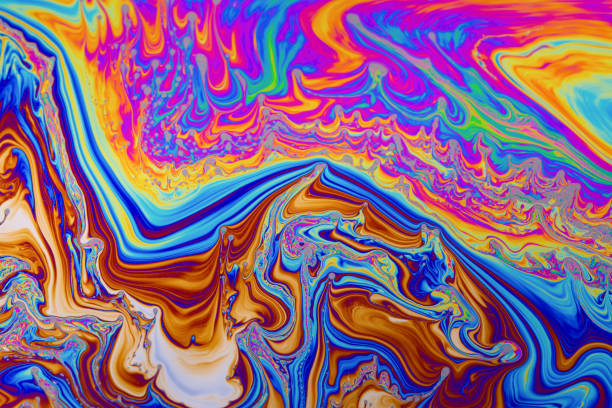 istock Rainbow colors. Psychedelic multi colored patterns background. Photo macro shot of soap bubbles 1340101389