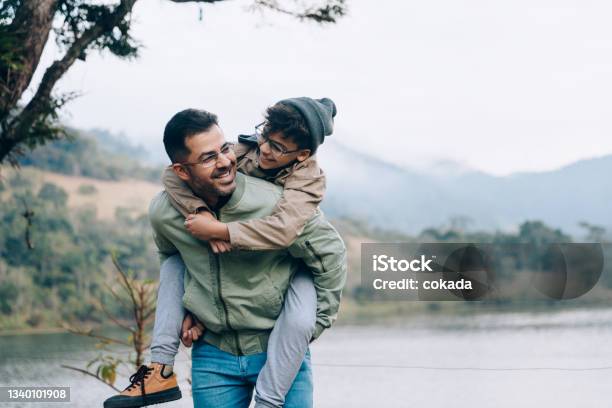 Father Carrying Son On His Back Stock Photo - Download Image Now - Family, Father, Winter