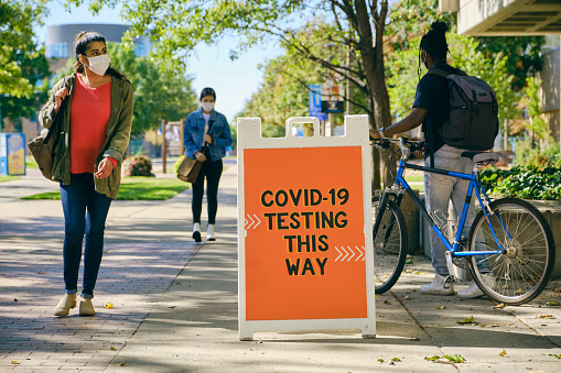 People entering and exiting a COVID testing location.