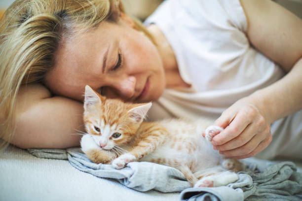 istock Young woman with her kitten 1340102864