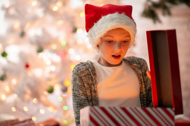 istock Young girl surprised with a Christmas gift 1340103333