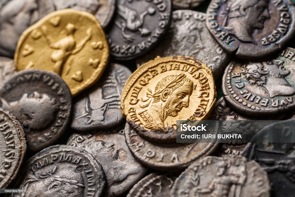 A treasure of Roman gold and silver coins.Trajan Decius. AD 249-251. AV Aureus.Ancient coin of the Roman Empire.Authentic  silver denarius, antoninianus,aureus of ancient Rome.Antikvariat. Coin Stock Photo