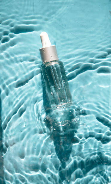 istock glass bottle with face serum on water drops 1340104976