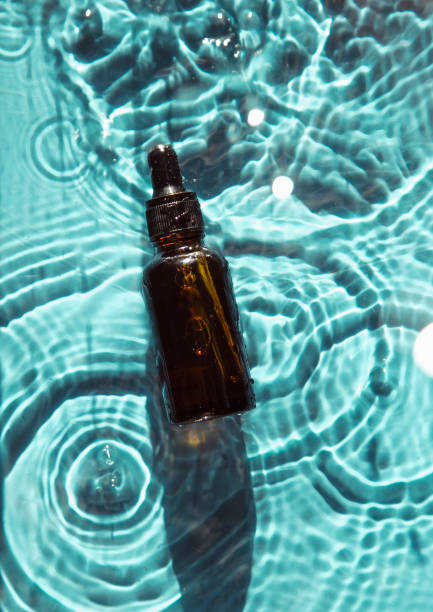 istock glass bottle with face serum on water drops 1340104977