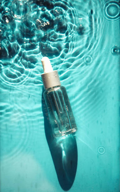 istock glass bottle with face serum on water drops 1340104979