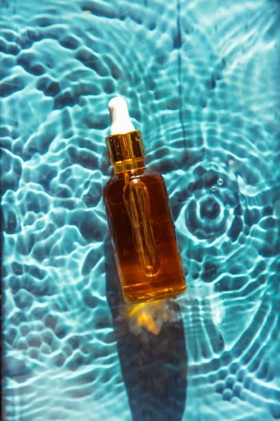 istock glass bottle with face serum on water drops 1340104986