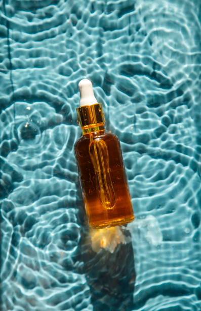 istock glass bottle with face serum on water drops 1340104992