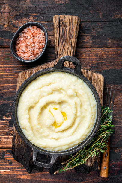 istock Mashed potatoes in a pan on wooden rustic table. Wooden background. Top view 1340108407